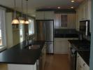 Kitchen w/ honed granite counters, bay window, & stainless steel appliances